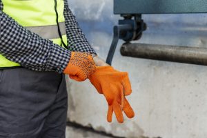 worker-putting-protective-gloves